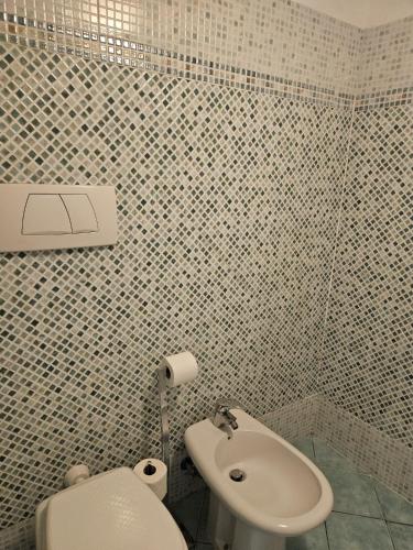 a bathroom with a toilet and a sink at A garden on the bay in Castiglioncello