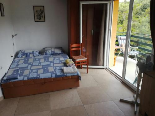 a bedroom with a bed and a balcony at Bigova Bay Apartments 2 in Bigovo