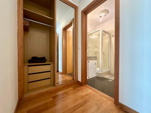 a bathroom with a walk in shower and a walk in closet at Sea Soul residencial in Funchal