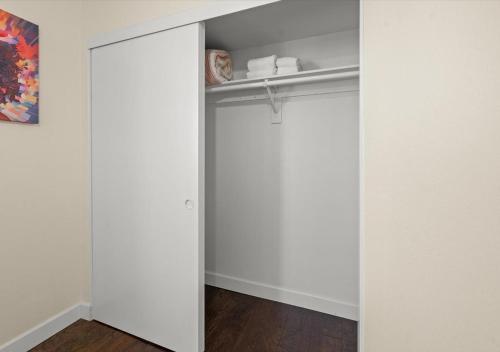 a closet with white walls and a sliding door at Cozy&Stylish DT Alhambra Living walk to Starbucks in Alhambra