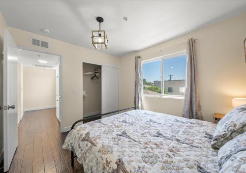 a bedroom with a large bed and a window at Cozy&Stylish DT Alhambra Living walk to Starbucks in Alhambra