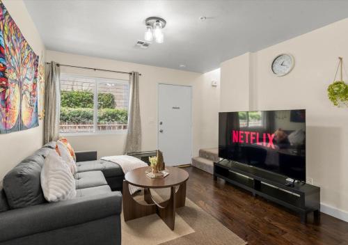 a living room with a couch and a tv at Cozy&Stylish DT Alhambra Living walk to Starbucks in Alhambra
