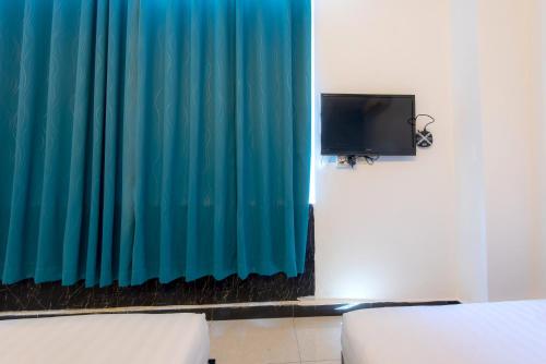 Una televisión o centro de entretenimiento en Hotel Pavilion Port