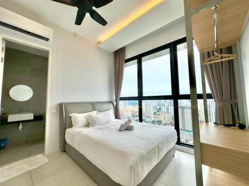 a bedroom with a bed and a large window at Cozy Urban Suites Georgetown View in Jelutong
