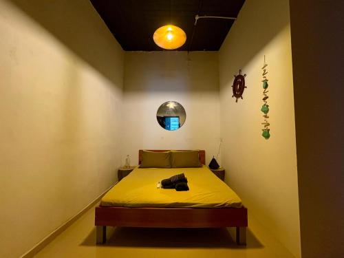 a bedroom with a bed with a yellow blanket at Sliema Room with ensuite bathroom, air-condition and spacious in Sliema