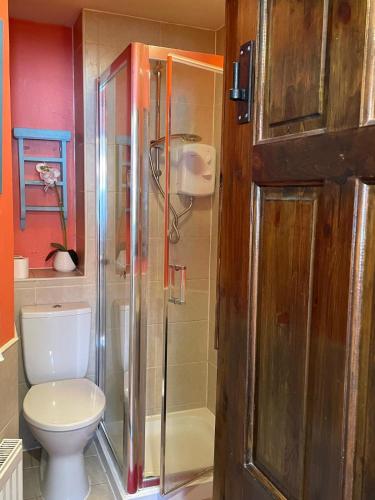 a bathroom with a toilet and a glass shower at Hayloft Sleep 2 NeXT to Fox Covert Pub in Kirk Leavington
