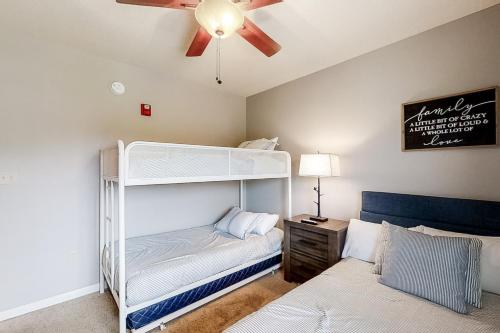 a bedroom with a bunk bed and a ceiling fan at Cedar Lodge #503 in Pigeon Forge