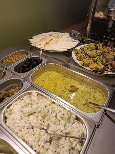 a buffet with many different types of food on a table at ECHIVITI Cottages in Abastumani in Abastumani