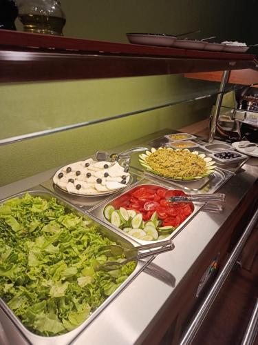 a buffet with different types of vegetables on a counter at ECHIVITI Cottages in Abastumani in Abastumani