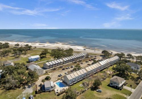 an aerial view of a building next to the beach at Steps from the Sand and Town Green - 2BR Coastal Retreat in Long Beach