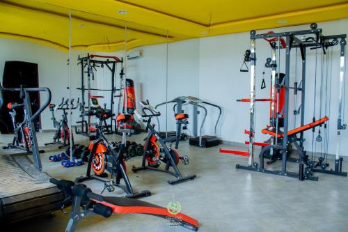 a gym with a bunch of bikes in a room at Maghaz Royal Hotel in Tamale