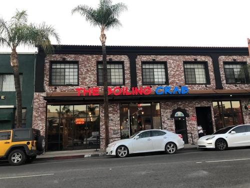 two white cars parked in front of a building at Cozy&Stylish DT Alhambra Living walk to Starbucks in Alhambra