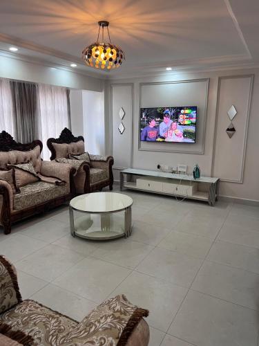 a living room with a couch and a tv at Spring den apartments in Rungiri