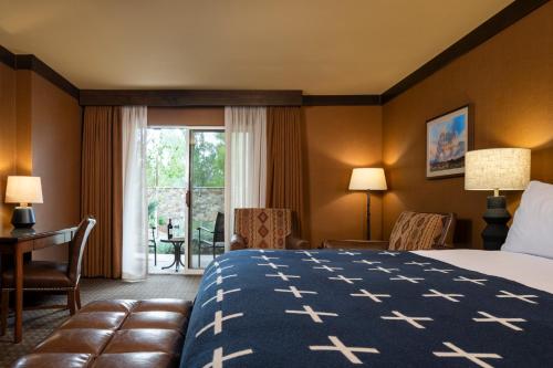 a hotel room with a bed and a window at Wayfinder Bishop in Bishop