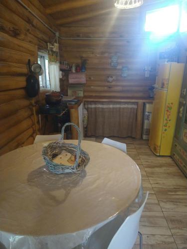 a kitchen with a table with a basket on it at Cabaña Gaia in Los Cocos