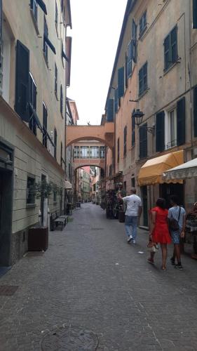 a group of people walking down a street with buildings at camera vacanza in Celle Ligure