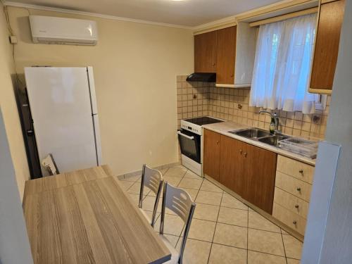 a kitchen with a table and a refrigerator at Loft Azure-Karfas in Chios