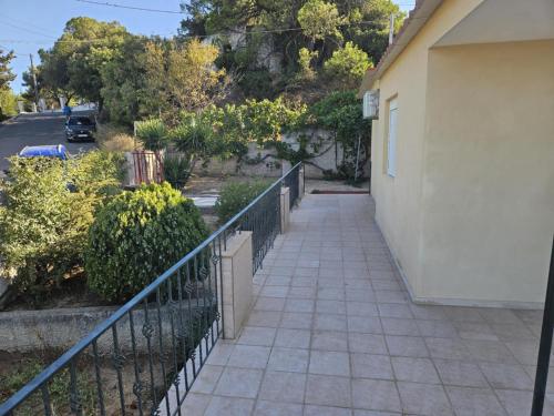 a walkway next to a building with a fence at Loft Azure-Karfas in Chios