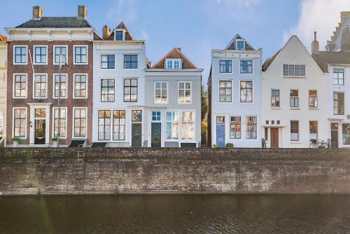 a group of buildings next to a river at Chambre d'hote à Middelburg in Middelburg