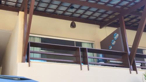 a balcony in a house with a window at Enseadas dos corais in Cabo de Santo Agostinho