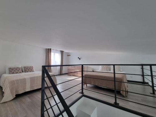 a room with a bed and a glass balcony at Factory's room in Montbertrand