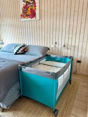 a bed with a blue frame in a bedroom at Casa Manzano ideal para Familias in Puerto Varas