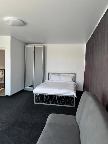 a bedroom with a bed and a couch at Дача in Kryvyi Rih