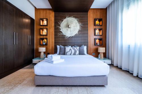 a bedroom with a large white bed and wooden walls at Penthouse d'Exception, Terrasse et Piscine Privée in Bouznika