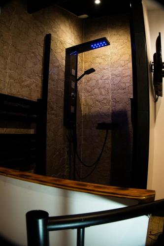 a bathroom with a shower with a blue light at CocooningRoom - Tain L'hermitage in Tain-lʼHermitage