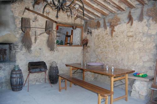 a room with a wooden table and a stone wall at Agriturismo San Ansanino- Piscina con spiaggia-Aria condizionata in Pari