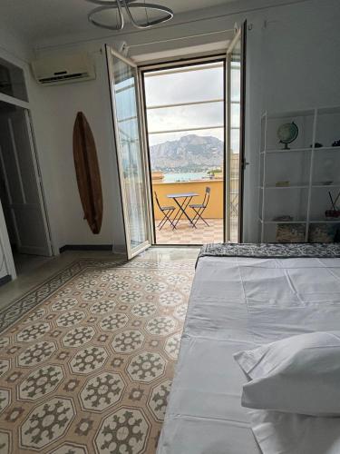 a bedroom with a bed and a view of a patio at Le Lunette Holiday House in Palermo