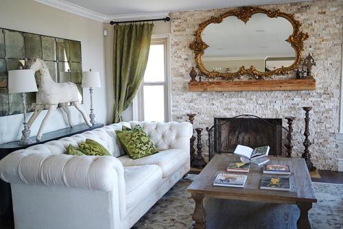 a living room with a white couch and a mirror at Villa on 5 Acre Vineyard Equestrian Estate, Pool & Hot tub, Events in Murrieta