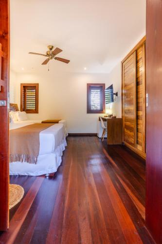 a bedroom with a bed and a ceiling fan at Aldeia Jericoacoara - Suites Privativas in Jericoacoara