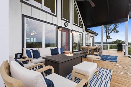 a living room with white furniture and large windows at Perch in the Clouds Hot Tub Stunning Views in Ellijay