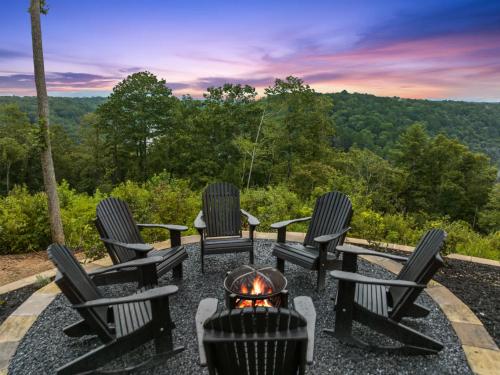 a group of chairs sitting around a fire pit at Perch in the Clouds Hot Tub Stunning Views in Ellijay
