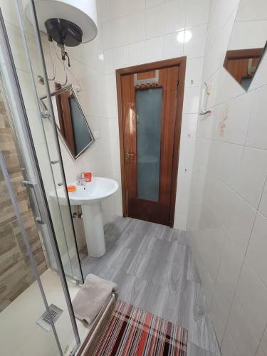 a bathroom with a shower and a sink and a mirror at Nice room with private bathroom in Ercolano