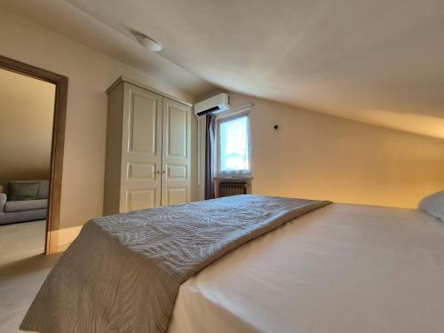 a bedroom with a large bed and a window at Kalimè in Alba
