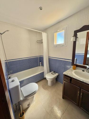 a bathroom with a toilet and a tub and a sink at Brisa Azul in Playas de Vera