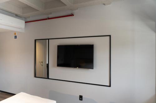a flat screen tv on a white wall at ibis Arcoverde in Arcoverde