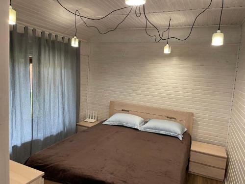 a bedroom with a large bed with two pillows at Еко будинок Duet in Maydan