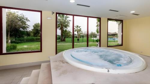 a large bath tub in a room with windows at Luxury 3 Beds Villa Inside Resort in Estepona