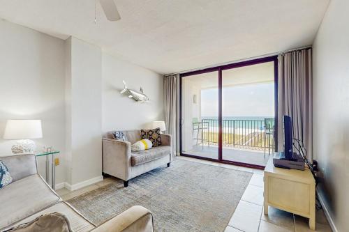 a living room with a couch and a tv at Emerald Surf 206 in Navarre