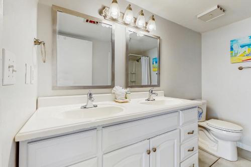 a white bathroom with a sink and a toilet at Emerald Surf 206 in Navarre