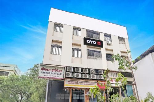 a white building with an ovo sign on it at Hotel O Yash Residency in Mumbai