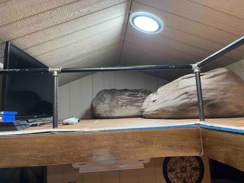 a bunk bed with two pillows on top of it at Cowboy Cabin at The Wild West 40 Homestead in Cane Beds