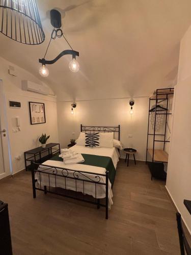 a bedroom with a large bed and a lamp at Il Giardino di Sole in Bari