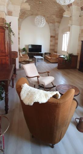 a large living room with a couch and tables at HiSalento in Surbo