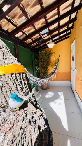 a hammock in a room with a plant at Villa Baobá Pousada & Spa in Búzios
