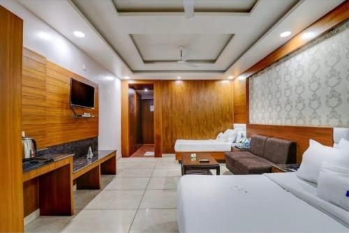 a hotel room with a bed and a couch at Pushap villa katra in Katra