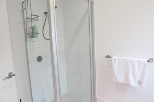 a bathroom with a shower with a glass door at Urban Virgo Escape in Caversham
